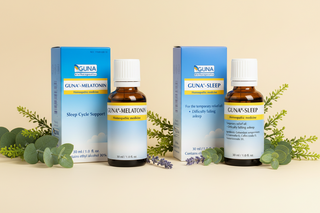 Two bottles of Guna Mela-tonin and Guna Sleep with their packaging on a white background