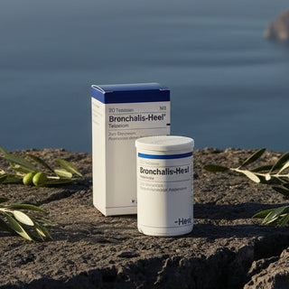 A box and a bottle of Bronchalis-Heel tablets with branding and product information displayed.